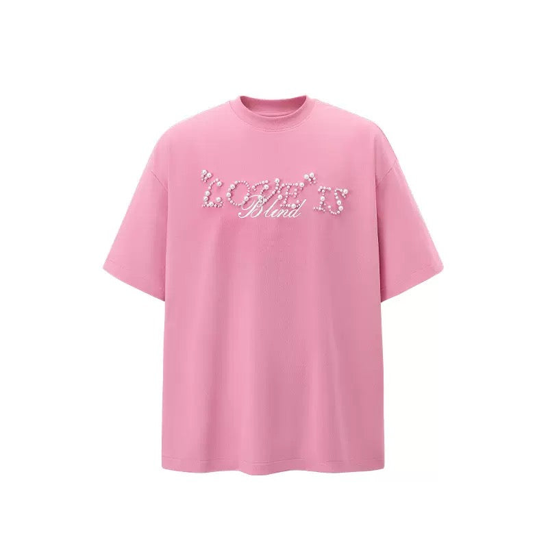 Pink oversized tee with pearl rhinestone Love Is Blind script on the front, streetwear style