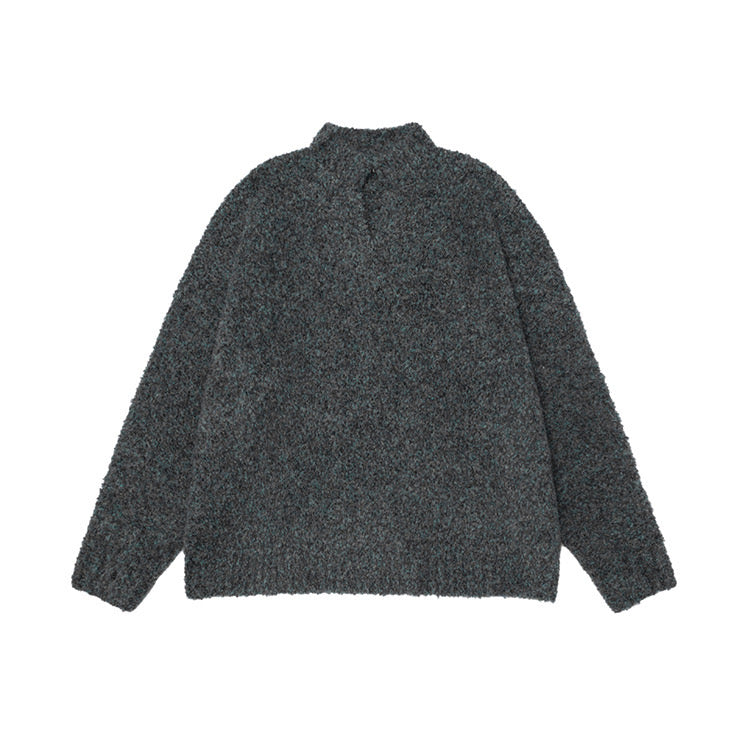 Back view of a charcoal grey boucle half-zip mock neck loose knit sweater on a white background