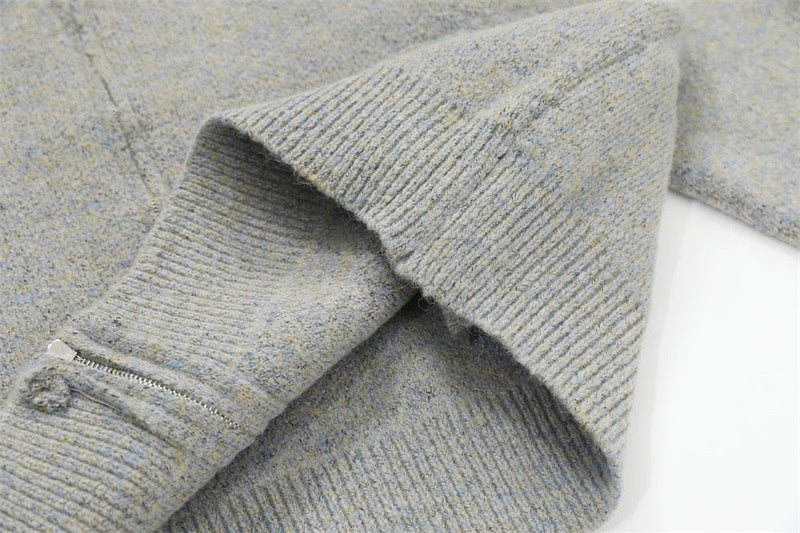 Close-up of light gray ribbed cuff and sleeve opening