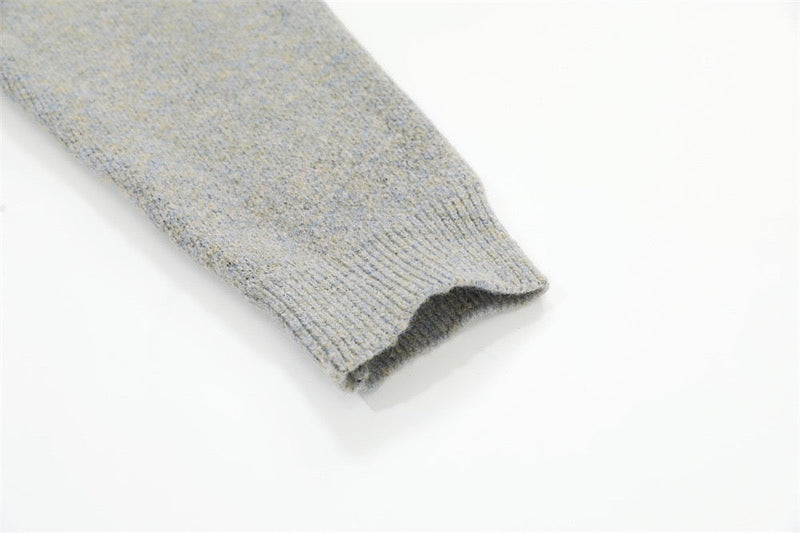 Close-up of light gray ribbed sleeve cuff