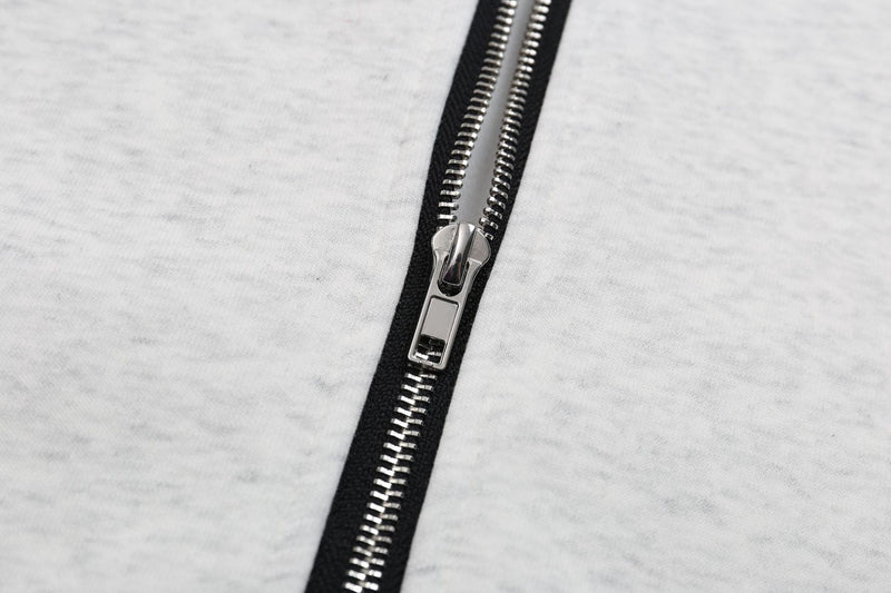 Close-up of silver zipper on ash grey cotton zip-up hoodie