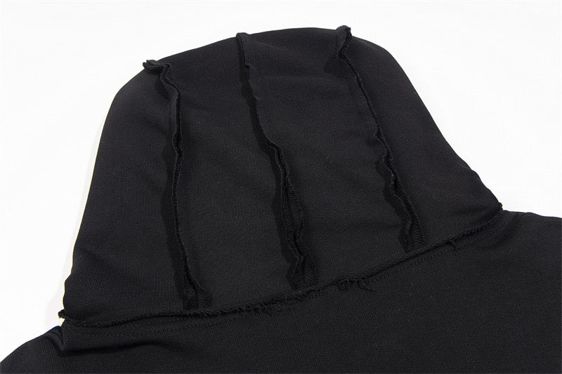 Close-up of black hoodie hood showing stitched seam details