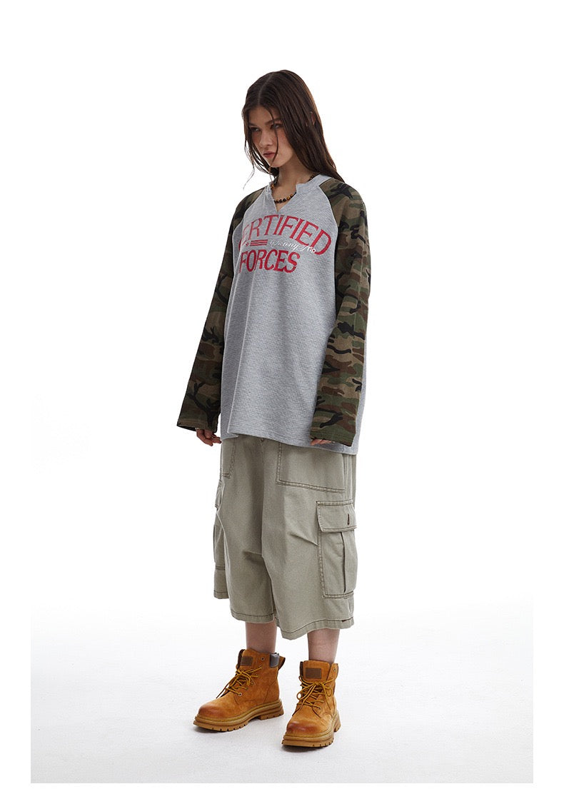 Three-quarter view of model wearing gray camouflage raglan thermal tee with red Certified Forces print