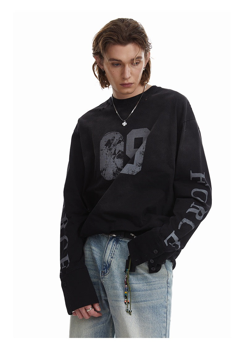 Black 69 graphic long-sleeve tee styled on model with wide sleeves and button cuffs