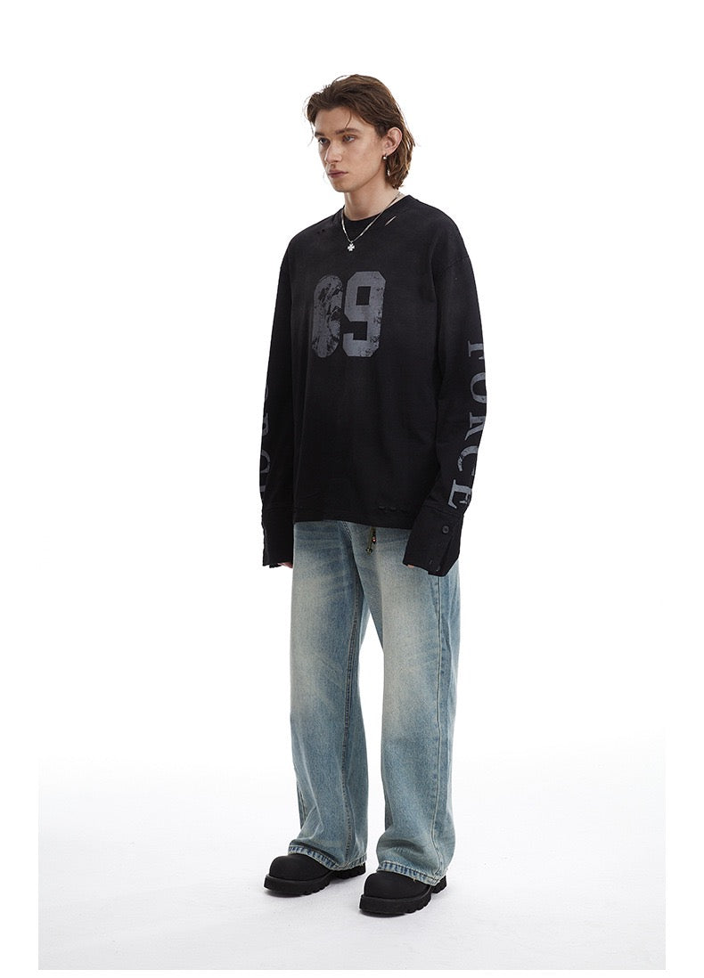 Black distressed 69 long-sleeve tee worn angled front view on model