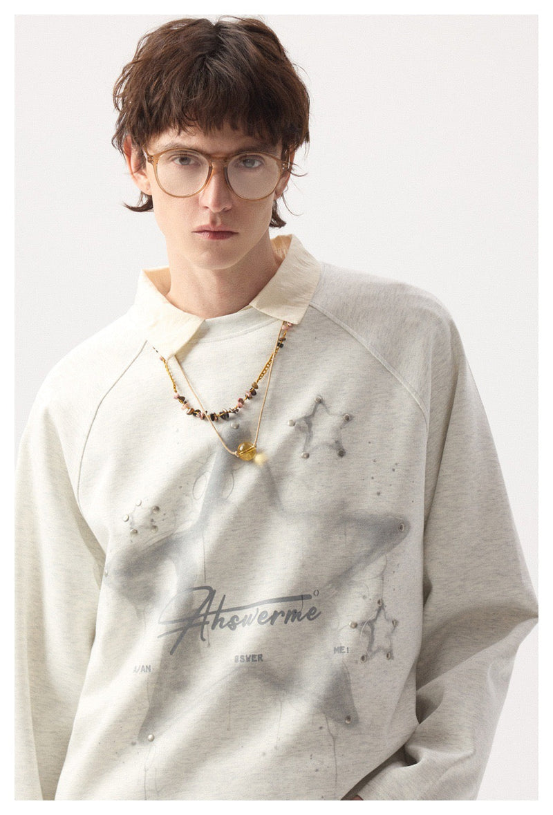 Model wearing light gray long sleeve tee with star graphic and collared layering