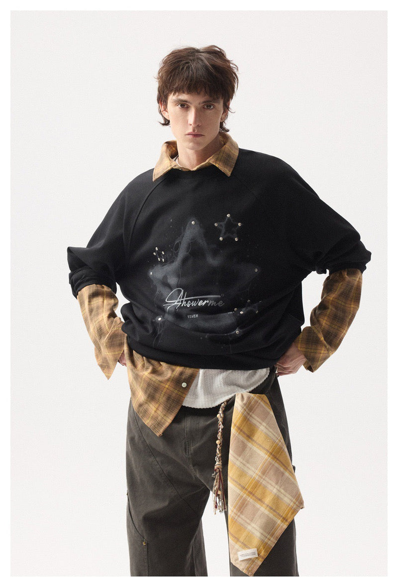 Black long sleeve tee styled with plaid shirt layers and wide-leg pants