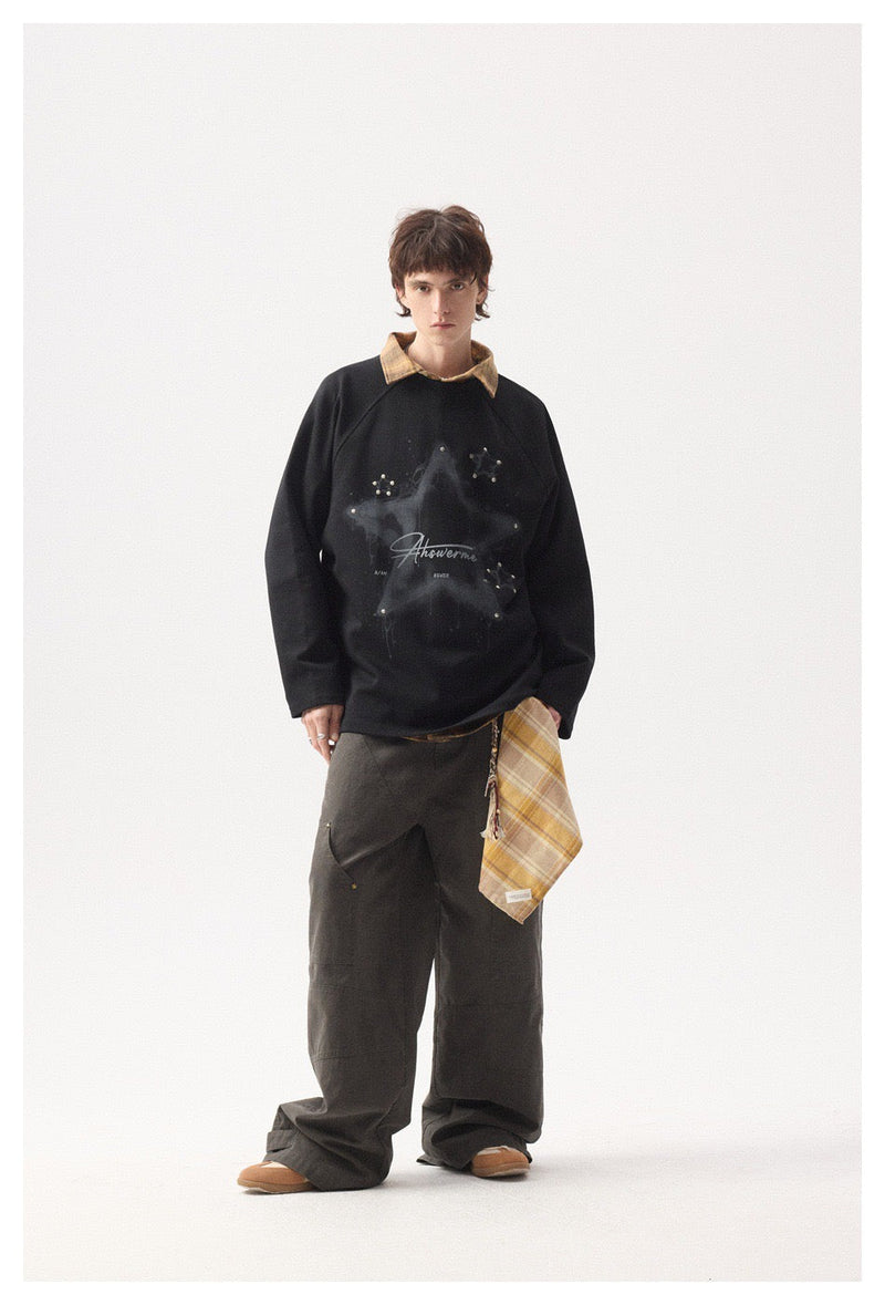 Full-length model view of black star graphic long sleeve tee with wide-leg pants