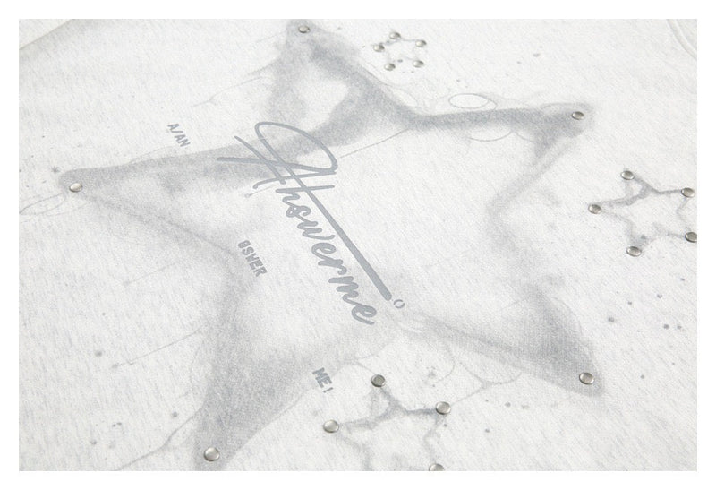 Close-up of star graphic and script print on light gray tee
