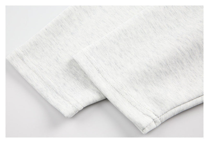 Close-up of light gray sleeve cuff and hem stitching