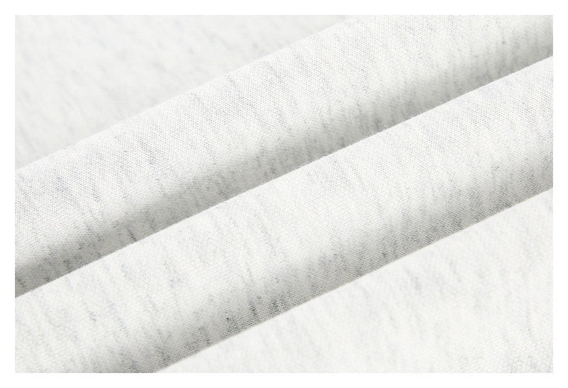 Close-up of layered sleeve fabric on light gray long sleeve tee