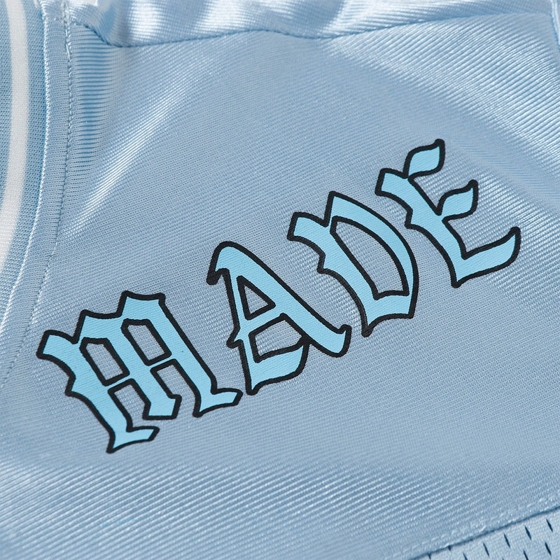 Light blue mesh varsity jersey with bold black outlined graphic lettering