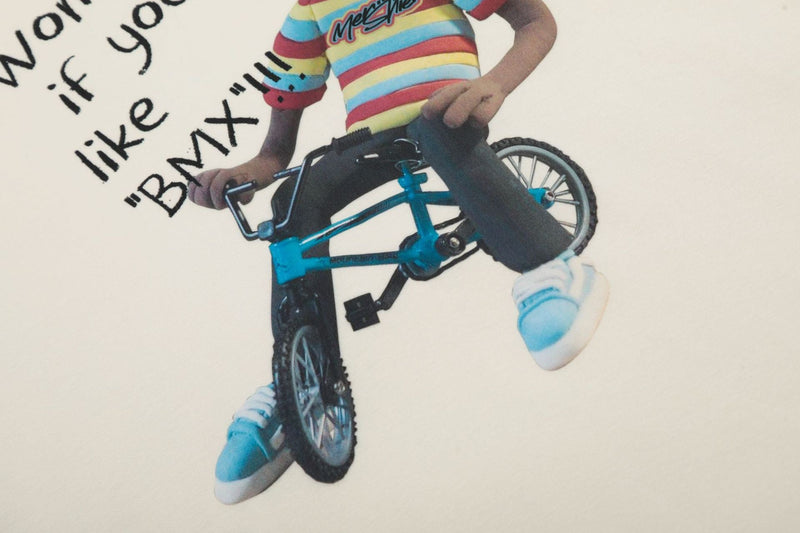 Front graphic close-up showing BMX rider and text on cream raglan tee