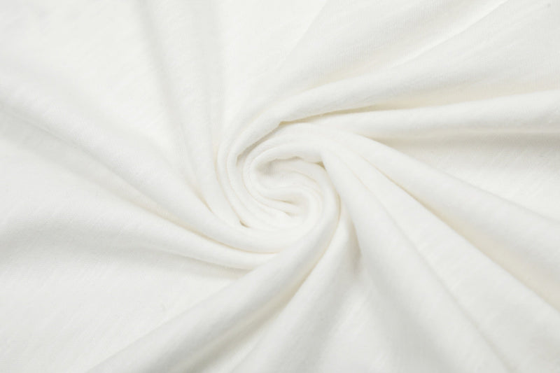 Close-up of white tee fabric folded in a soft spiral