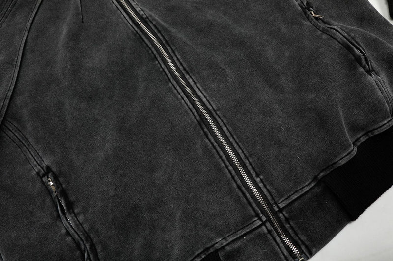 Close-up of charcoal hoodie front zipper and shaped seam panels