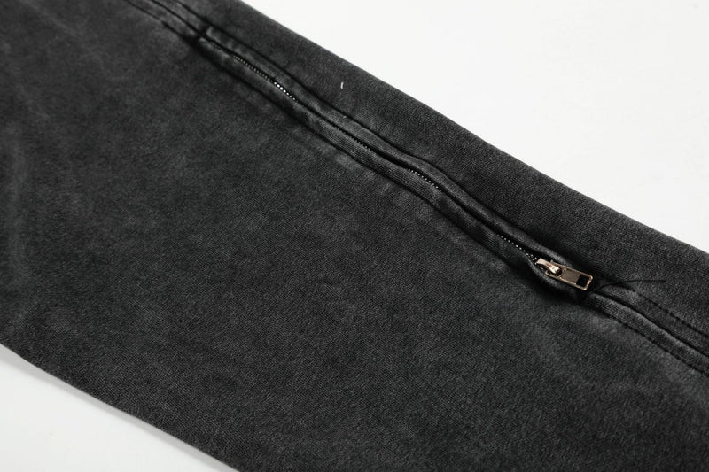 Close-up of charcoal hoodie sleeve zipper pocket and seam detail