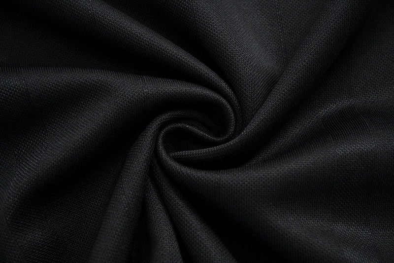 Close-up of black performance mesh fabric with a textured weave and soft draped folds