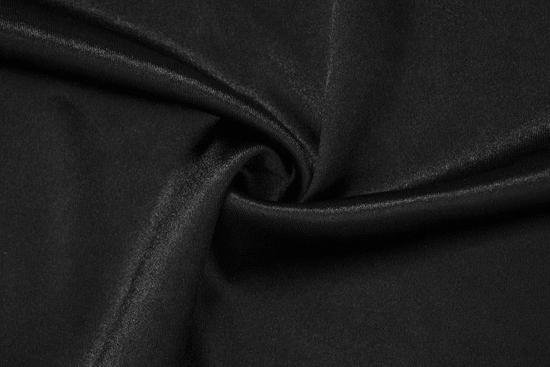 Close-up of black satin-like jersey fabric with gathered texture