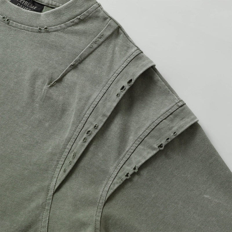 Washed olive green distressed panel tee with raw seam details and layered streetwear design