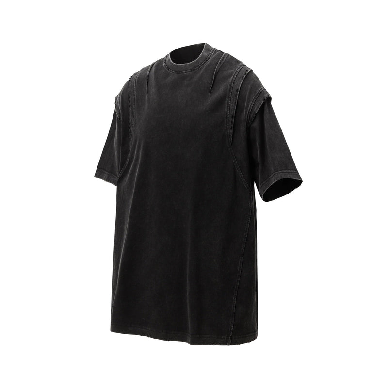Washed black oversized tee with distressed panel seams and vintage faded streetwear look