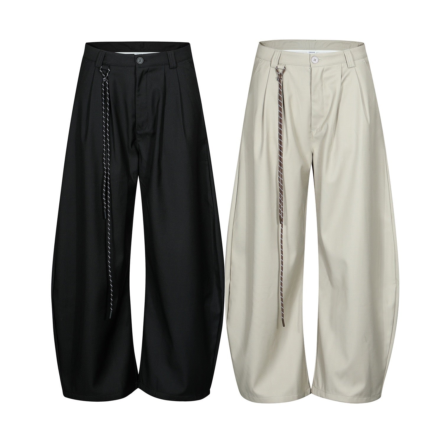 Black and stone wide-leg pleated trousers with twisted hanging strap detail, shown as a flat lay product pair
