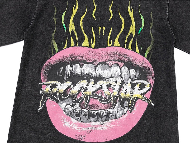 Washed black graphic tee with pink flaming mouth print and bold Rockstar logo