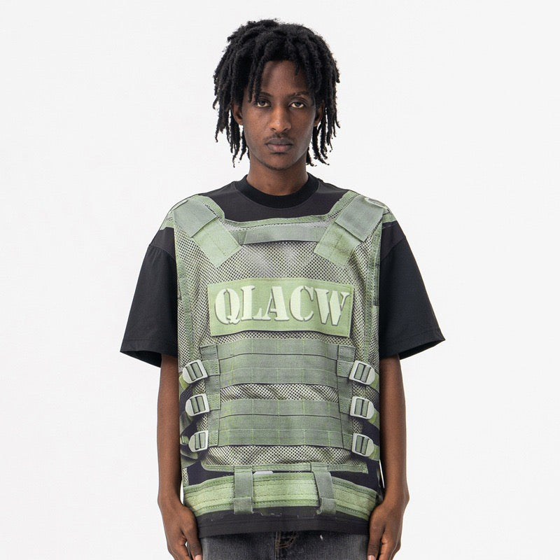 Model wearing a black tactical vest illusion graphic tee with green military-style print and front buckle details