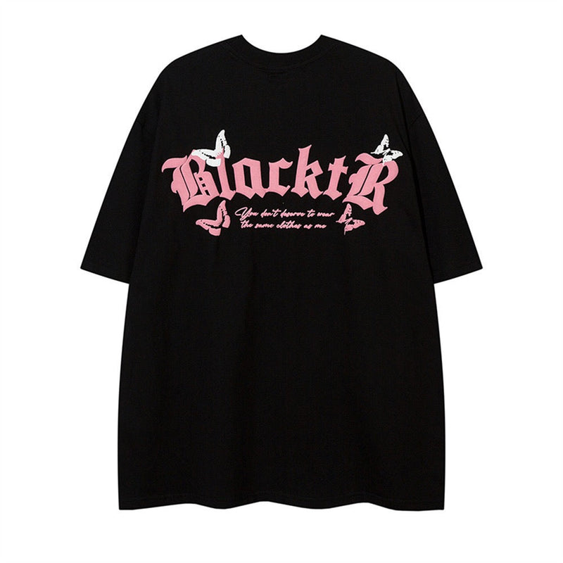 Black oversized tee with pink gothic lettering and butterfly graphics on the chest