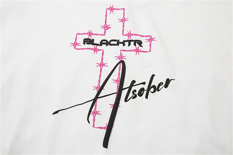 White graphic tee with pink star-trimmed cross and black Blacktr Atsober lettering on the chest