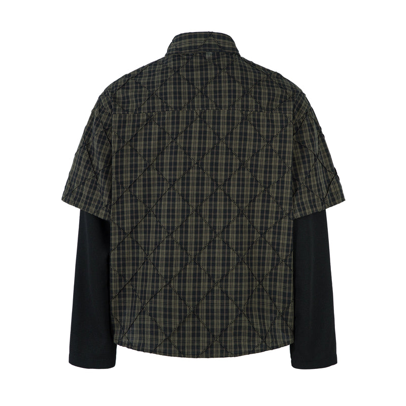 Back view of black plaid quilted layered shirt with short sleeves and long black undersleeves