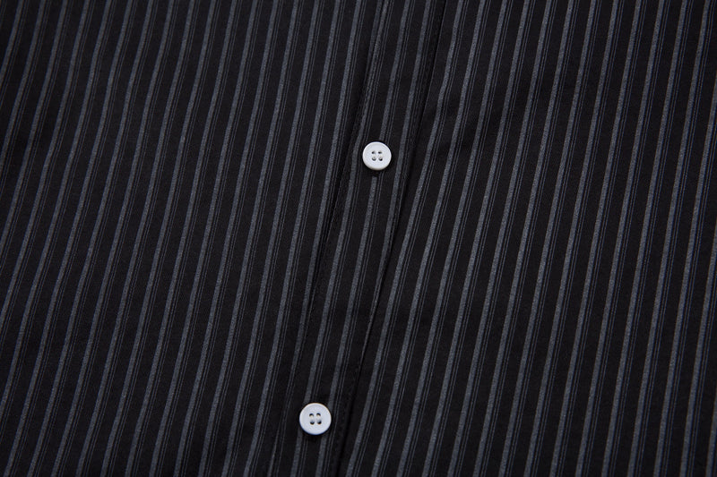 Close-up of black pinstripe fabric and white front button