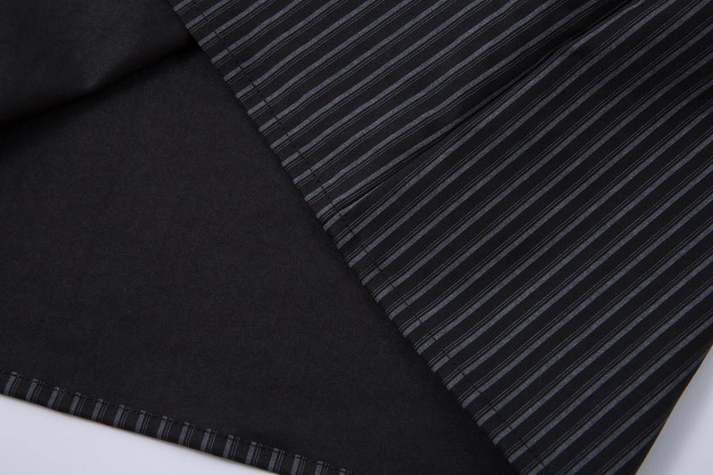 Diagonal close-up of black pinstripe hem and layered inner panel