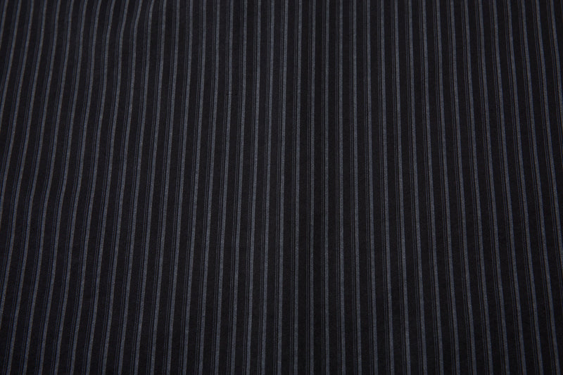 Close-up of black shirt fabric with narrow gray vertical pinstripes