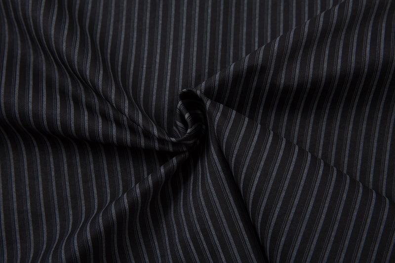Wrinkled black pinstripe fabric close-up with vertical gray stripes
