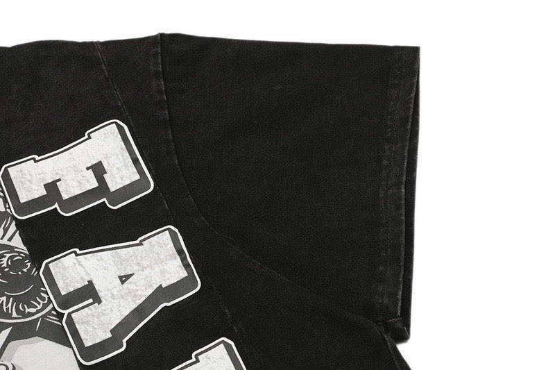 Black cropped boxy graphic tee with bold white gothic lettering and saint faith cross panel print on sleeve and chest