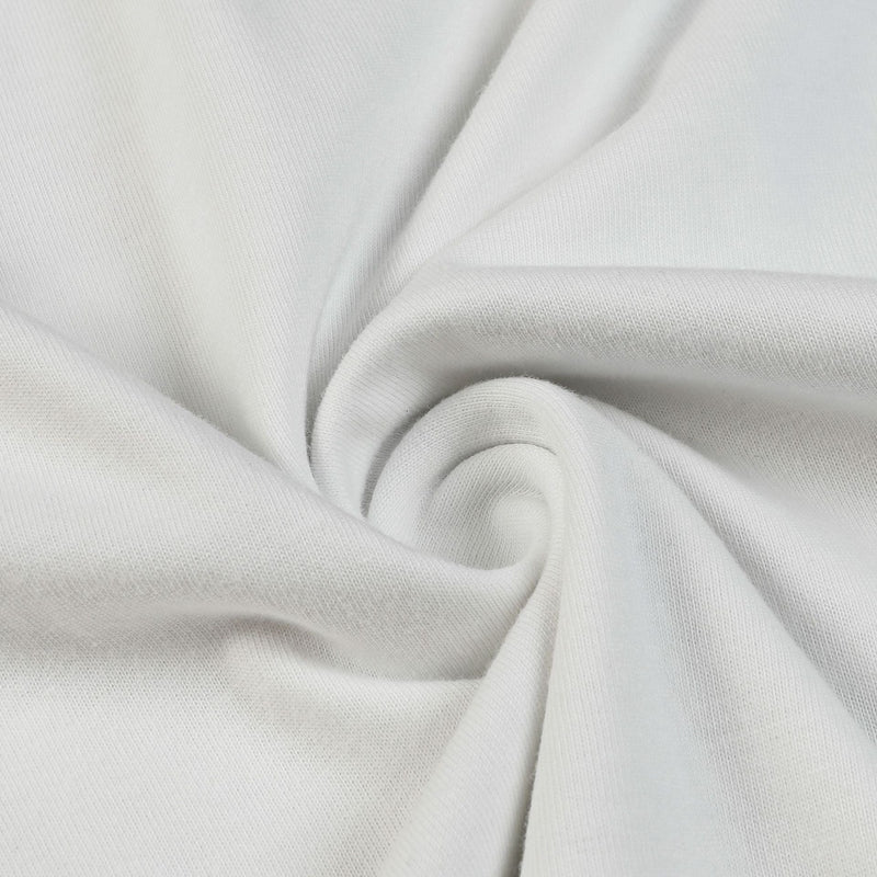 White cotton fabric close-up with soft folds and smooth knit texture for a streetwear graphic tee