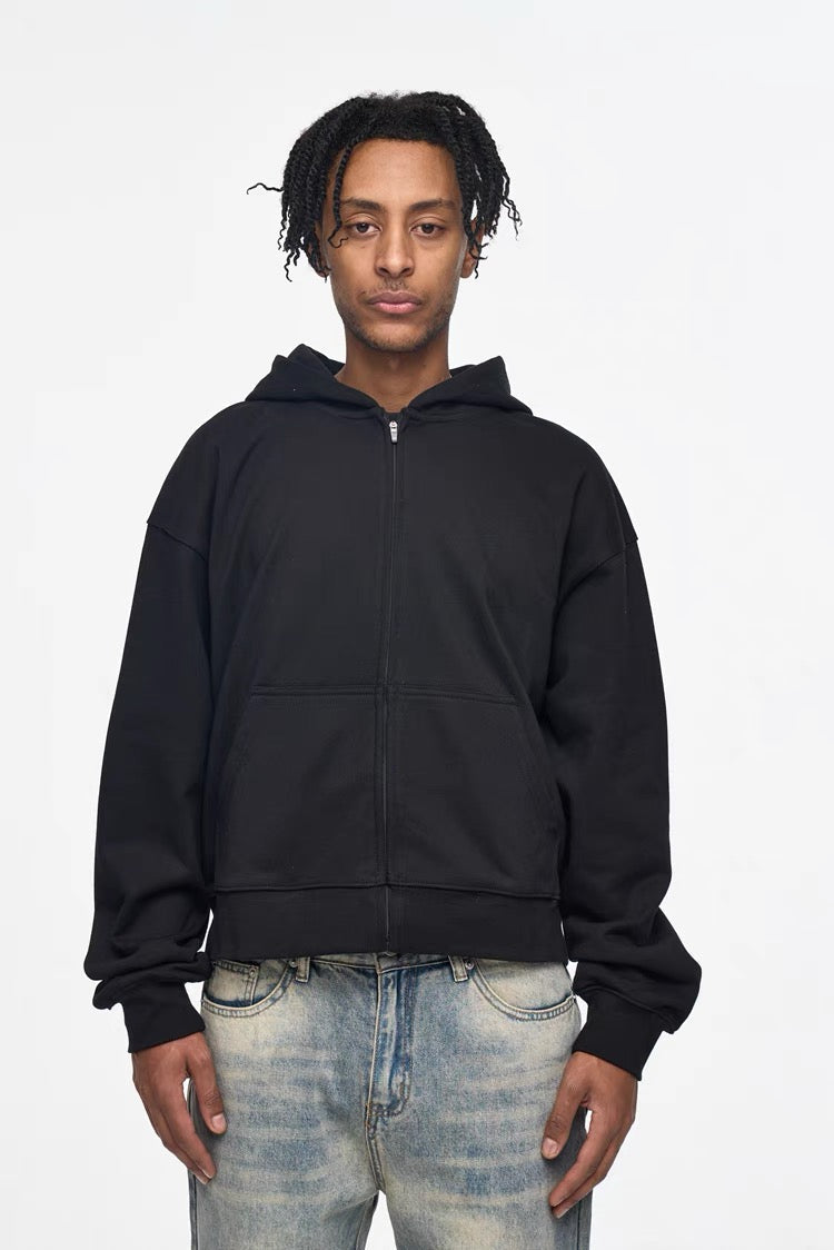 Black zip-up cropped hoodie worn by model, front view