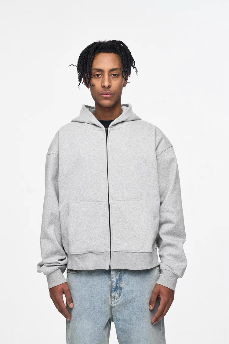 Light gray zip-up cropped hoodie worn by model, front view