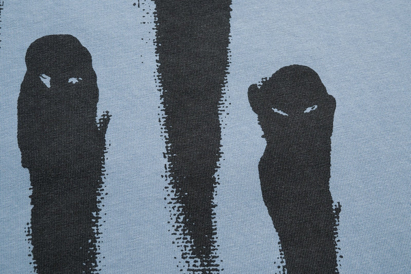 Light blue tee with three black ghost shadow graphics and distressed streetwear style print