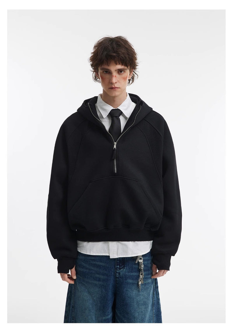 Black cropped hoodie worn over shirt and tie with wide jeans, front view