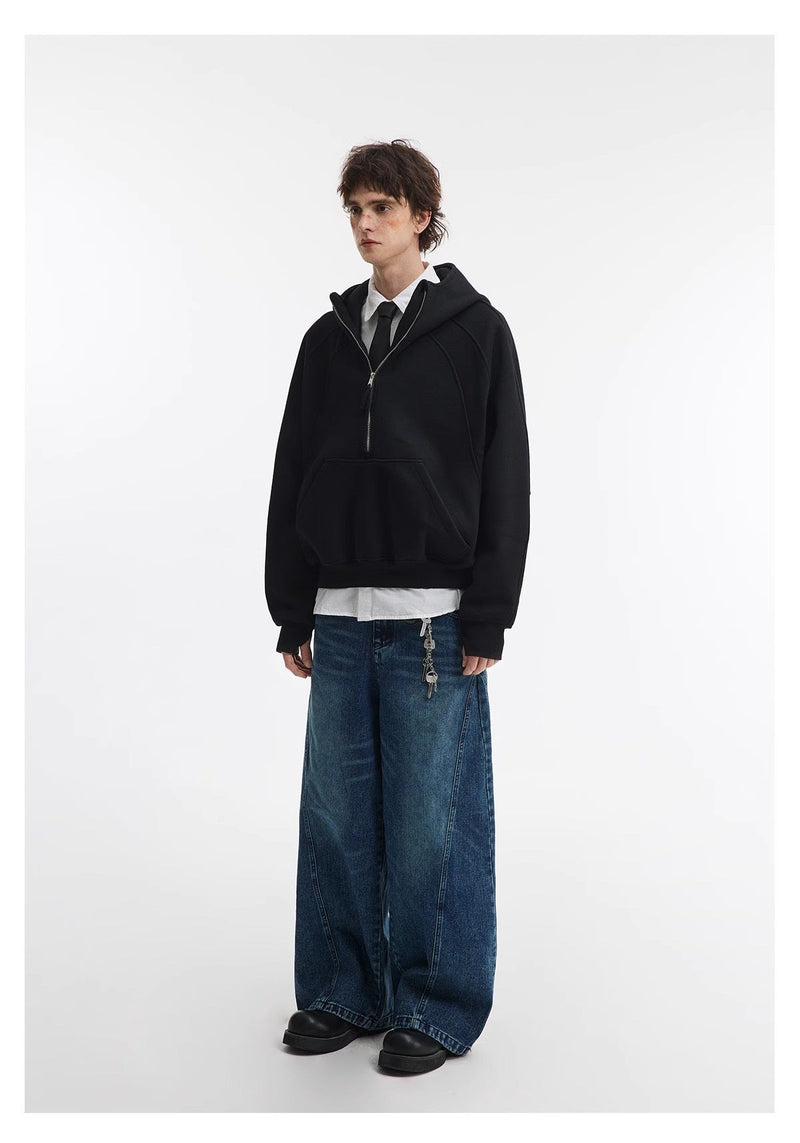 Black cropped hoodie worn with wide-leg jeans and layered shirt, three-quarter view