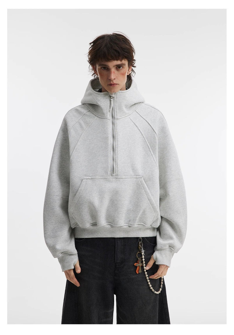 Light gray cropped hoodie worn with black pants, front model view