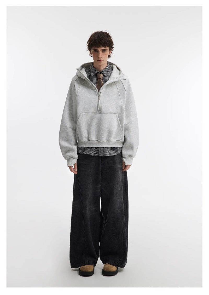 Light gray cropped hoodie worn with wide black pants, front model view