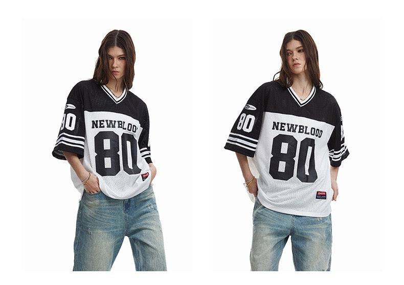 Black and white oversized football jersey tee with NEWBLOOD 80 graphic, shown on two models with relaxed streetwear fit
