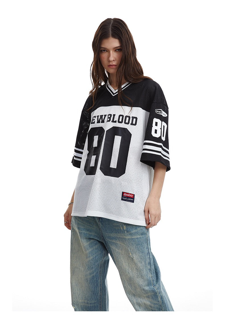 Black and white oversized mesh football jersey tee with Newblood 80 print and wide sleeves, styled with faded jeans