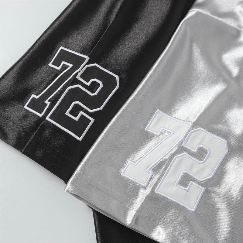 Close-up of black and silver mesh football jersey tees with bold white embroidered 72 numbers on the sleeves