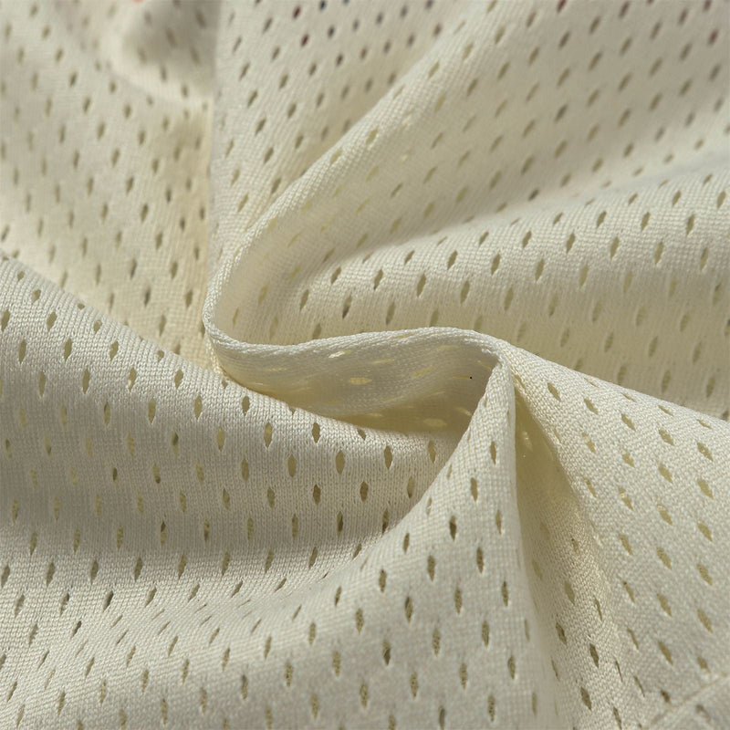 Close-up of cream mesh jersey fabric with breathable perforations and soft draped folds