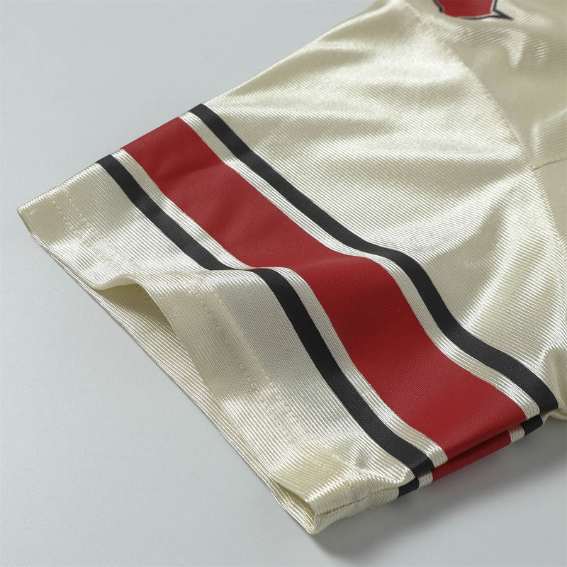 Cream retro football jersey tee with red and black striped sleeves in shiny satin streetwear style