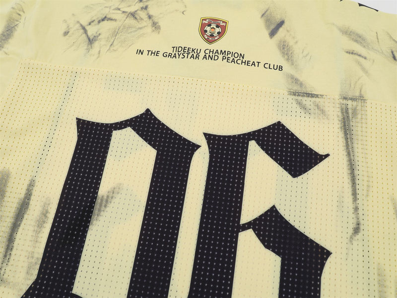 Washed yellow athletic mesh jersey tee with black graphic print and small crest logo on the chest