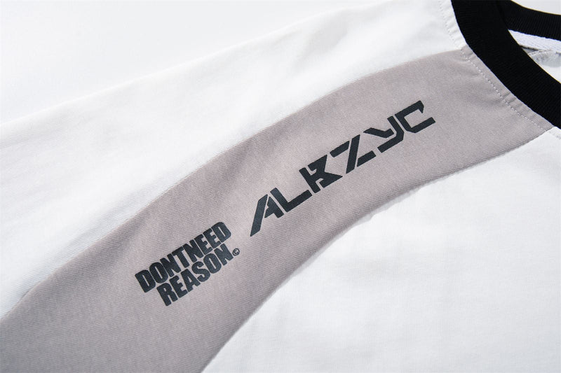 Close-up of a white and gray raglan streetwear tee with black collar and printed Forgotten 07 graphic on the sleeve